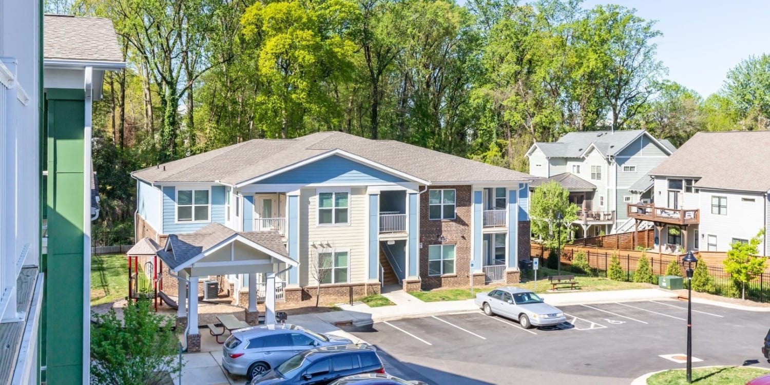 Multi-level apartments showcasing parking lot at Baxter Street in Charlotte, North Carolina