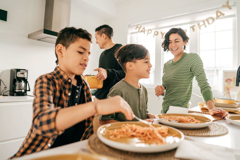 Residents cooking dinner together at home at Baxter Street in Charlotte, North Carolina