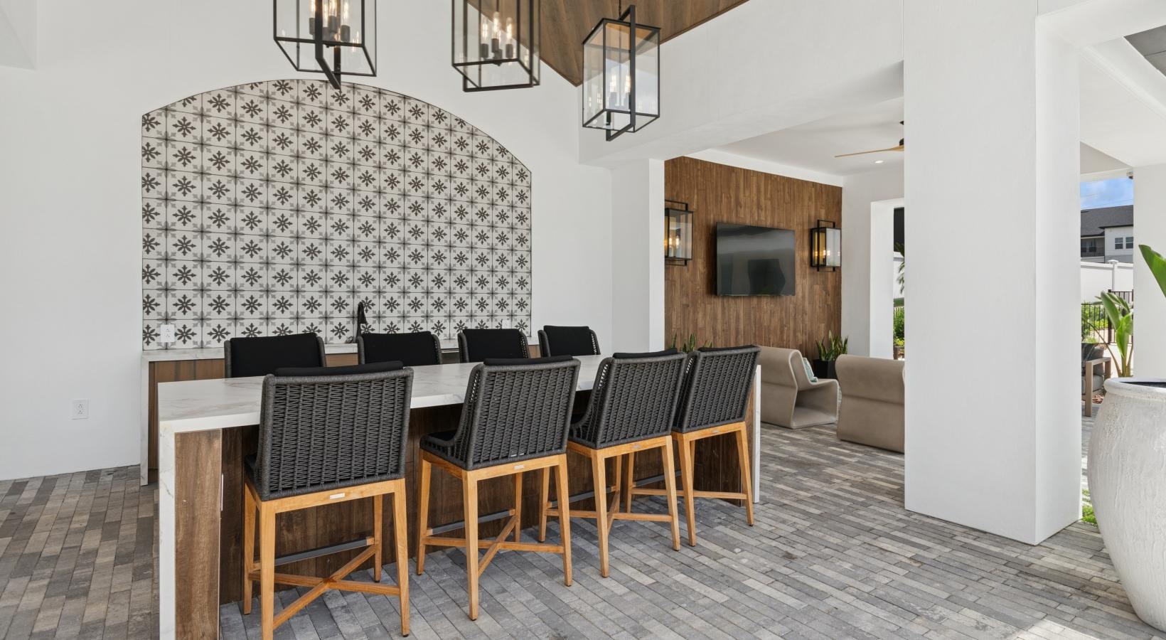a room with a table chairs and a chandelier