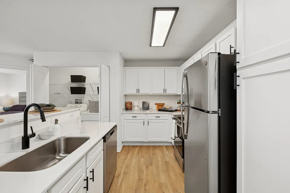 Modern kitchen design with sleek stainless steel appliances, elegant white cabinetry, and a spacious layout perfect for culinary exploration.