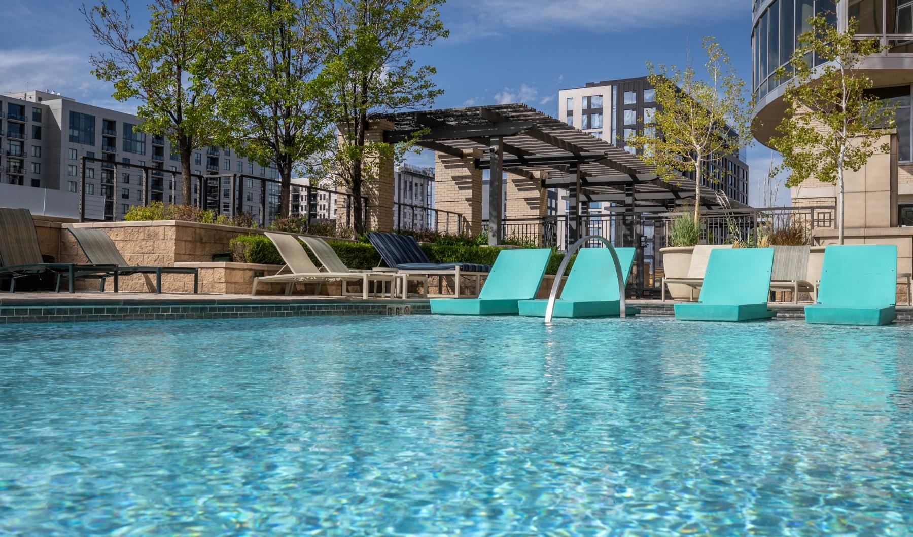Resort-style swimming pool with lounge seating