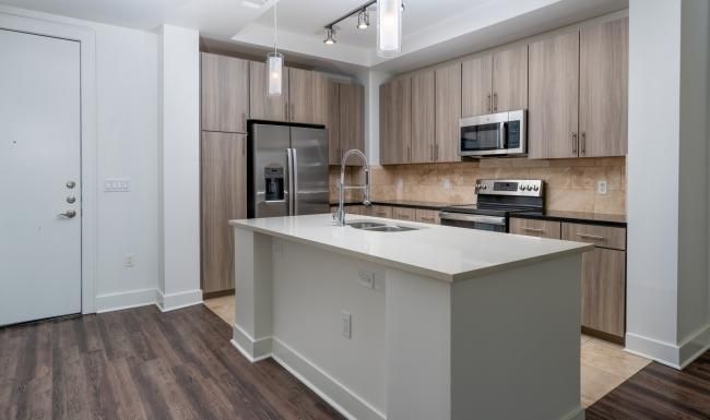 a kitchen with wooden cabinets