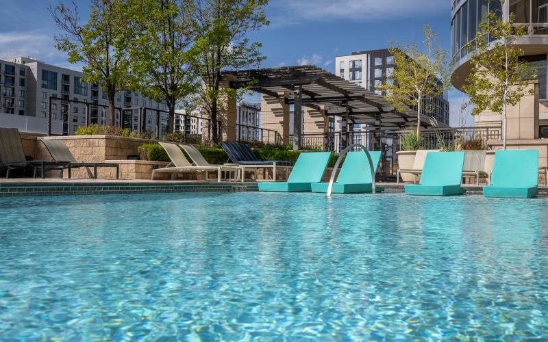 Resort-style swimming pool with lounge seating