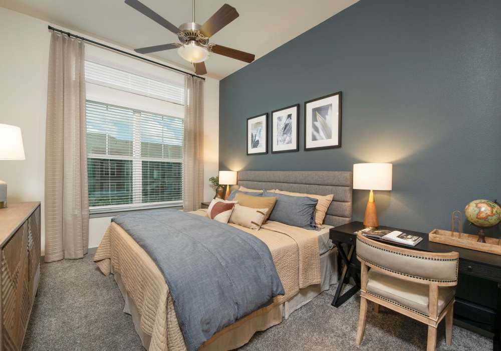 Model bedroom with carpet flooring at Orleans at Fannin Station in Houston, Texas