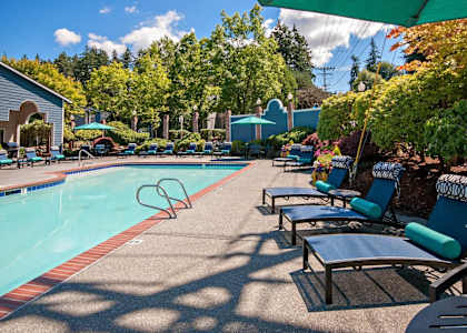 A poolside area with sun loungers and a swimming pool. at Brackett Apartments, Edmonds, 98020