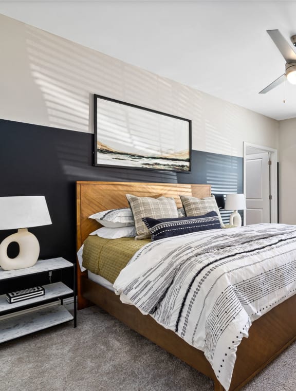 a bedroom with a bed and a ceiling fan