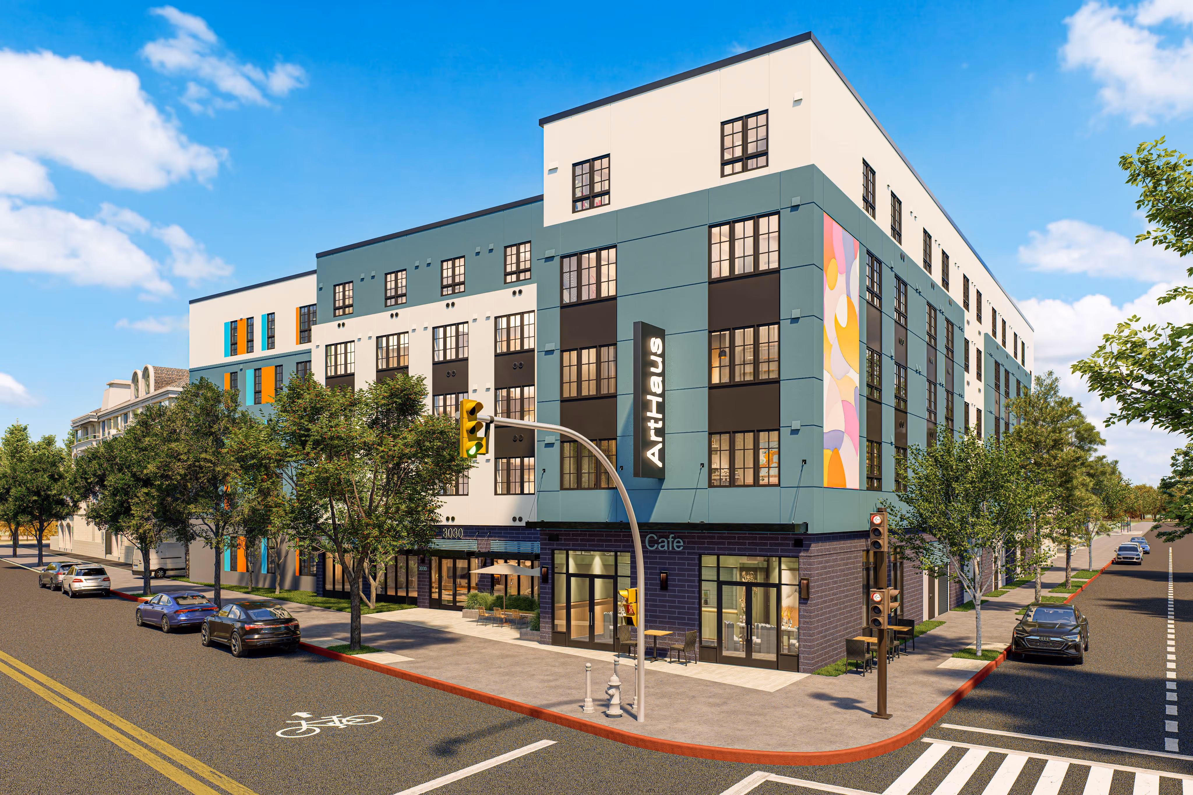Exterior street view of the modern, mixed-use apartment building with vibrant art panels, featuring retail space (Cafe) on the ground floor at ArtHaus Telegraph in Berkeley, CA.