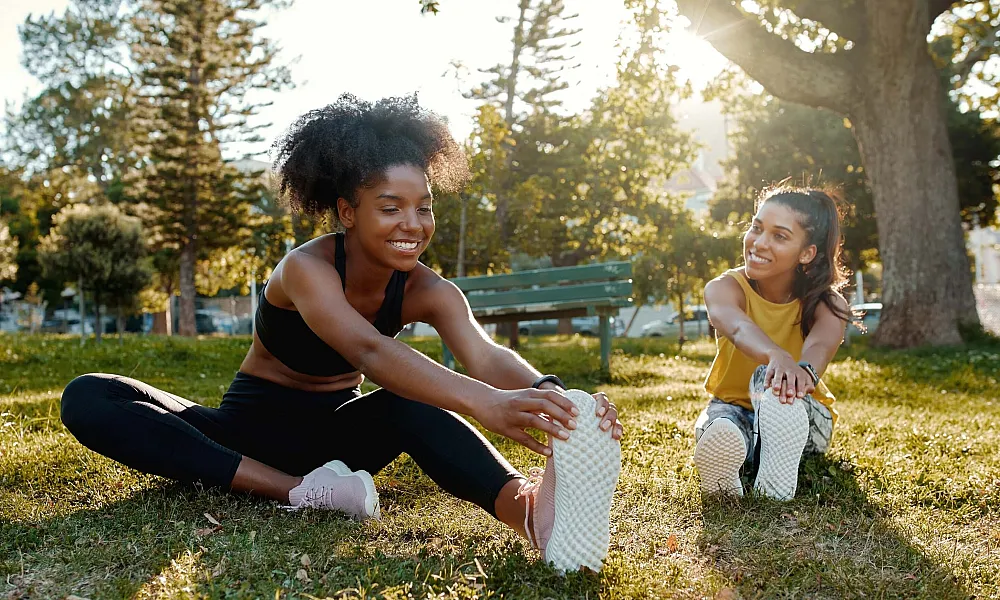 women stretching in a park