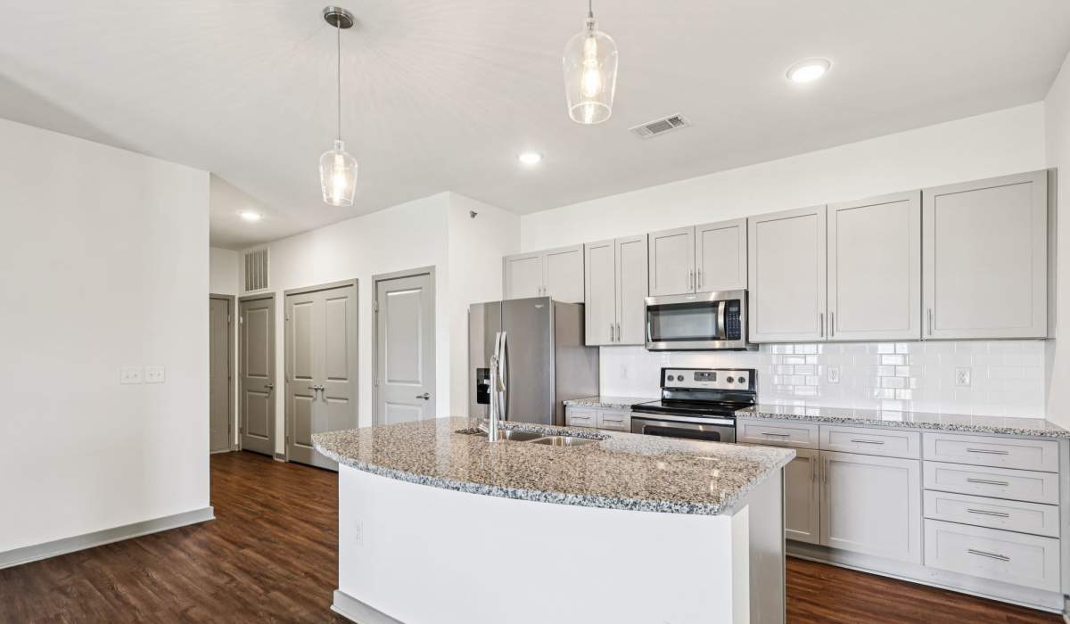 Kitchen with side by side refrigerator and wooden flooring at The Drake in Bowling Green, Kentucky 
