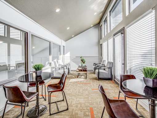 A modern dining room with a glass table and chairs.