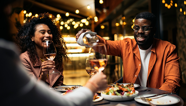People smiling and drinking wine