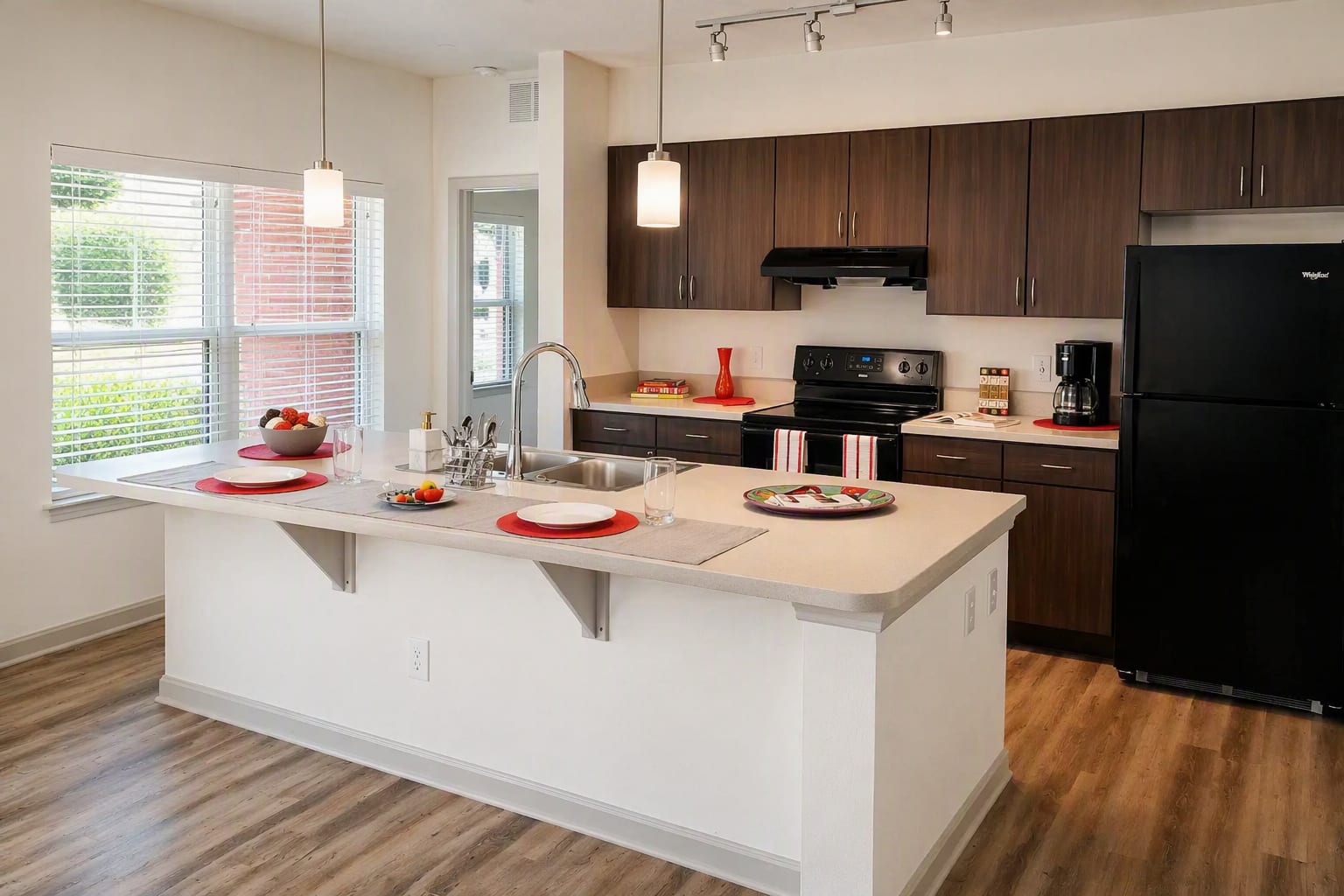 Modern apartment kitchen with dark wood cabinetry at The Veranda at North Main in Columbia, South Carolina 