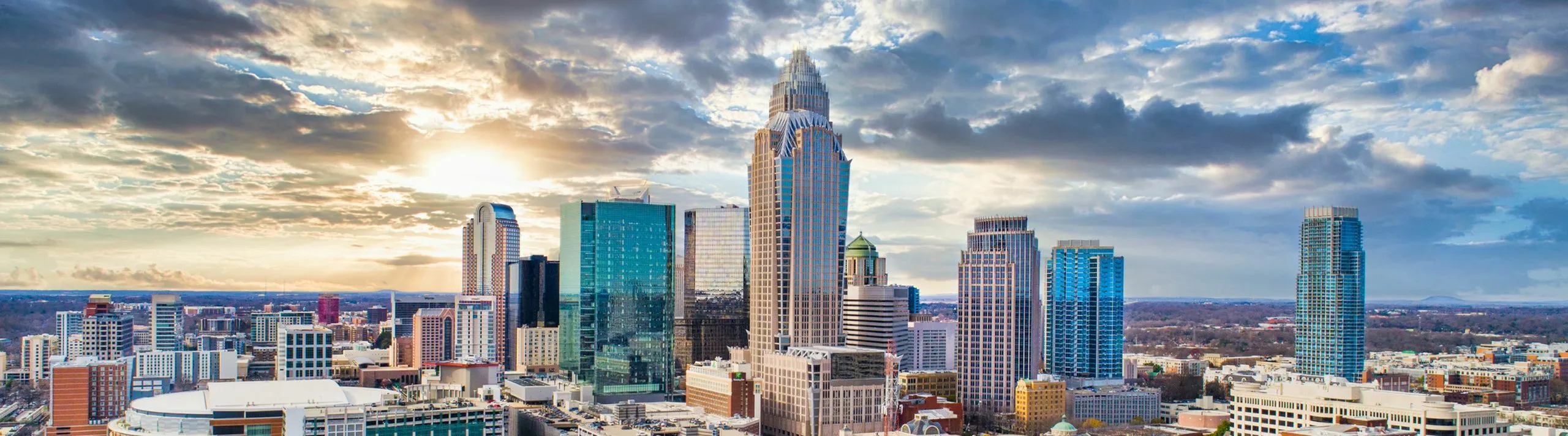 Stunning city skyline at sunset with modern skyscrapers and a vibrant urban landscape.