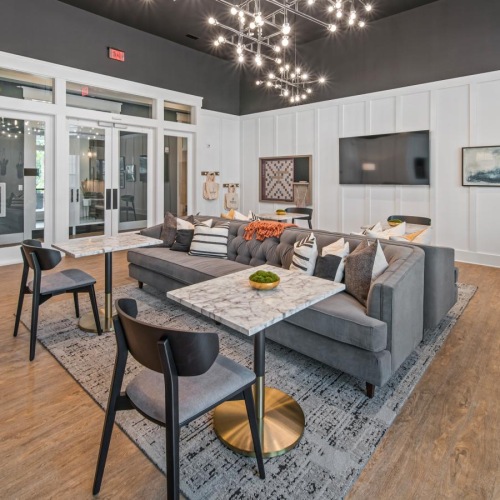 a living room with a large dining table and chairs