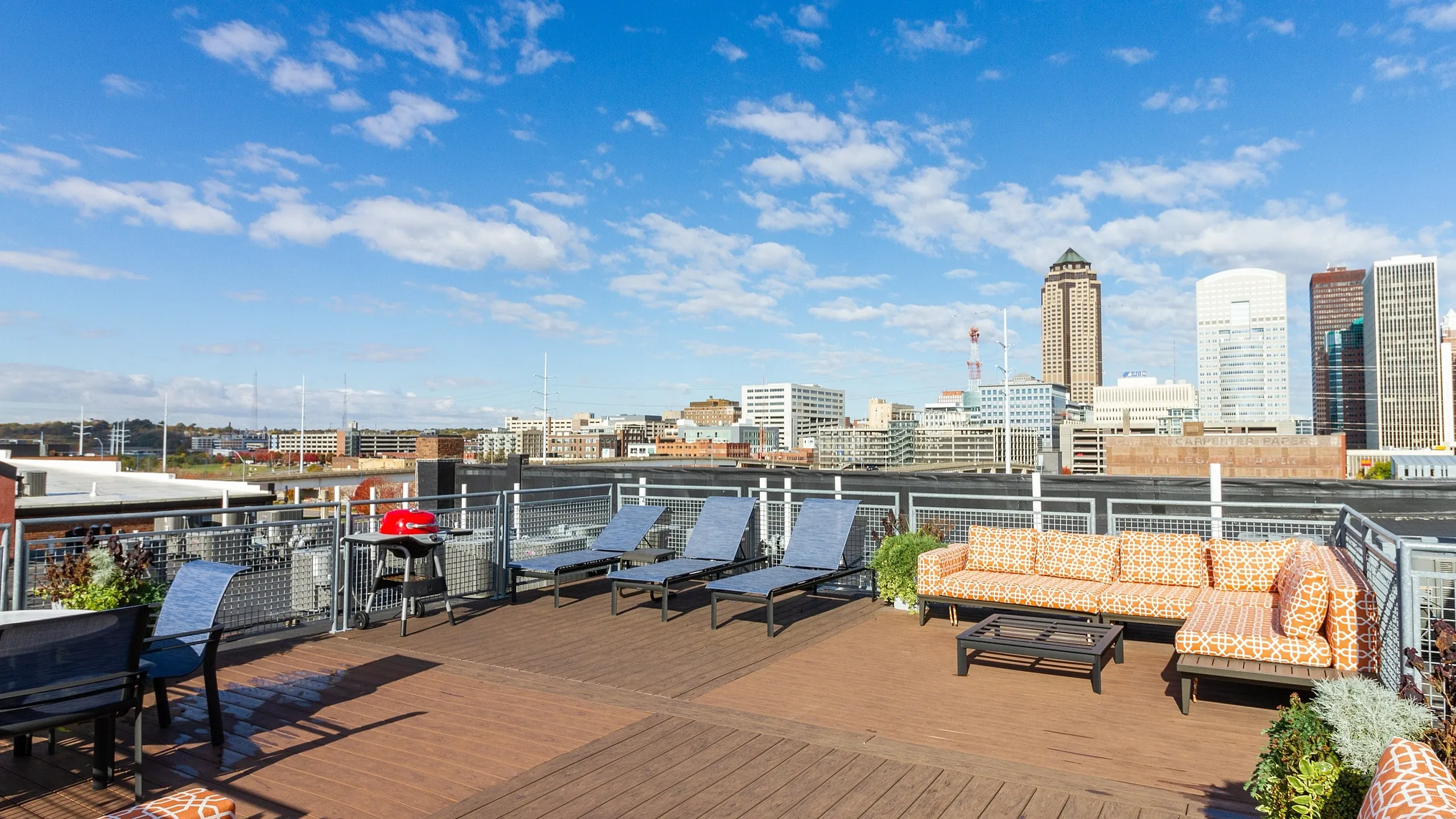 Vibrant rooftop terrace with stylish seating and stunning city skyline views, perfect for entertaining.