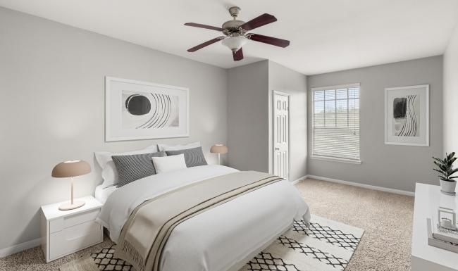 a bedroom with a bed and a fan