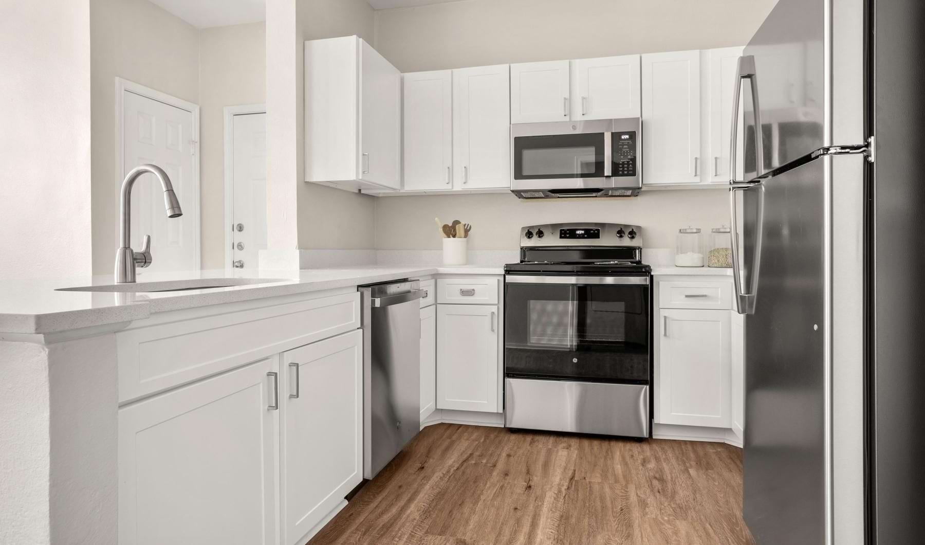 a kitchen with white cabinets