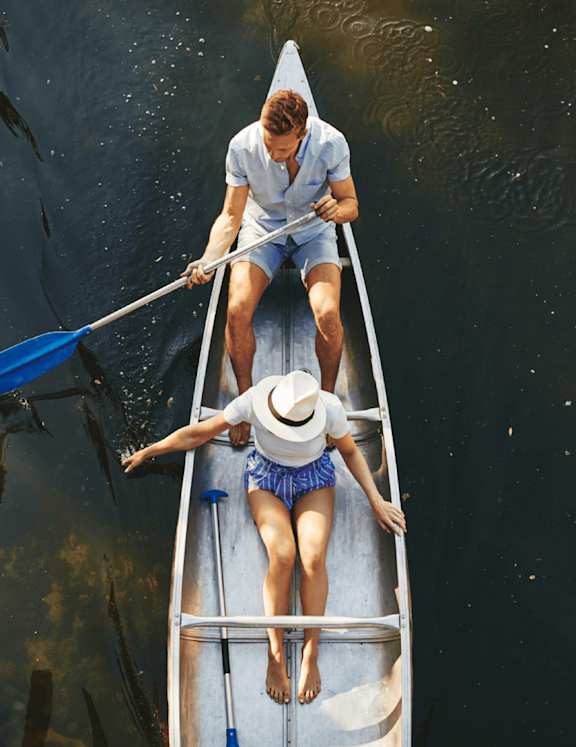 Man and Woman Rowing a Boat Together