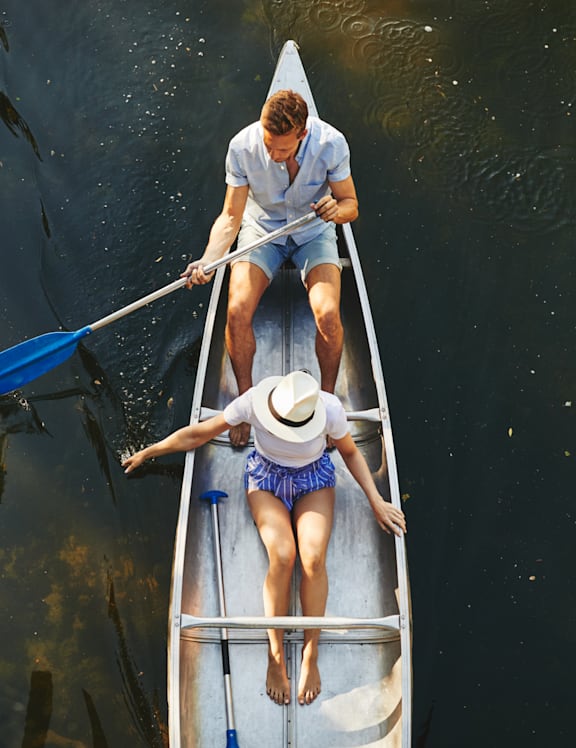 Man and Woman Rowing a Boat Together