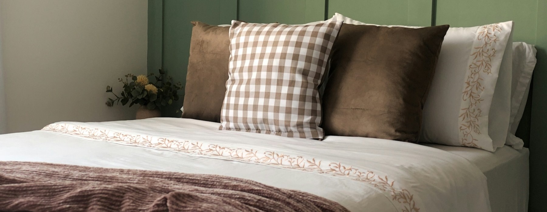 a bedroom with a bed and pillows