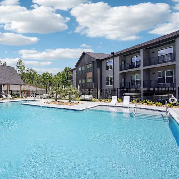 our apartments have a large swimming pool with an umbrella at The Pullman Luxury Apartments, Atlanta, GA, 30349