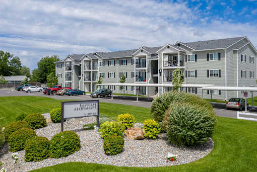 A building with the sign "Fairway Apartments" in front of it.
