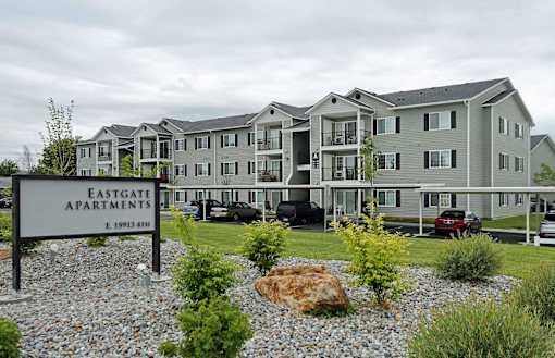 A large building with a sign that says Eastgate Apartments.
