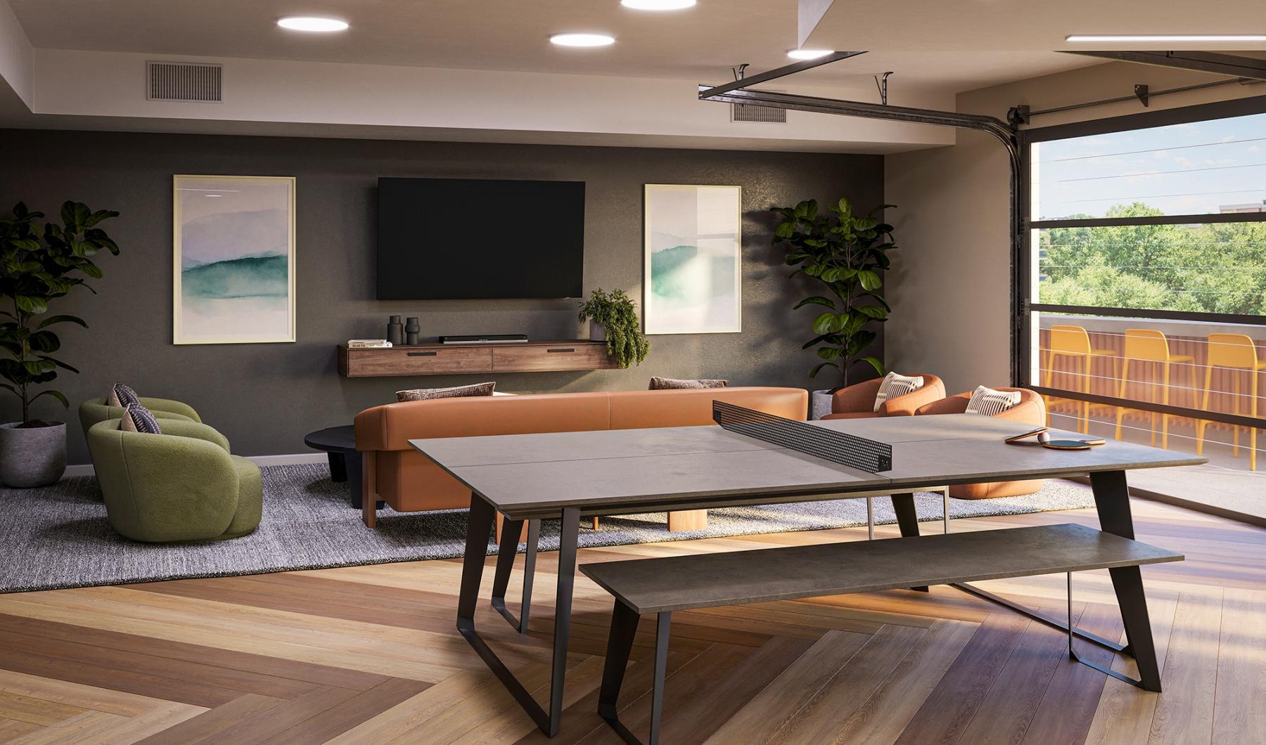 a room with a ping pong table seating and tv