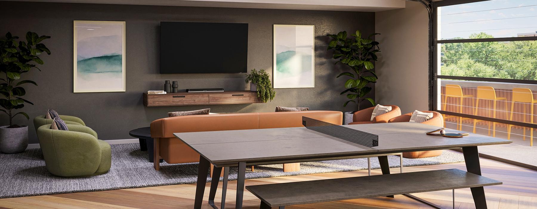 a room with a ping pong table seating and tv