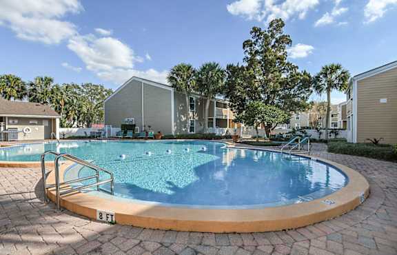 a swimming pool with apartments in the background