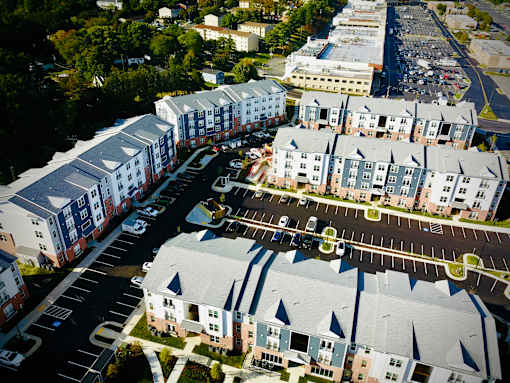 Apartment complexes with parking lots in front.