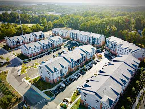 A large apartment complex with multiple buildings and parking lots.