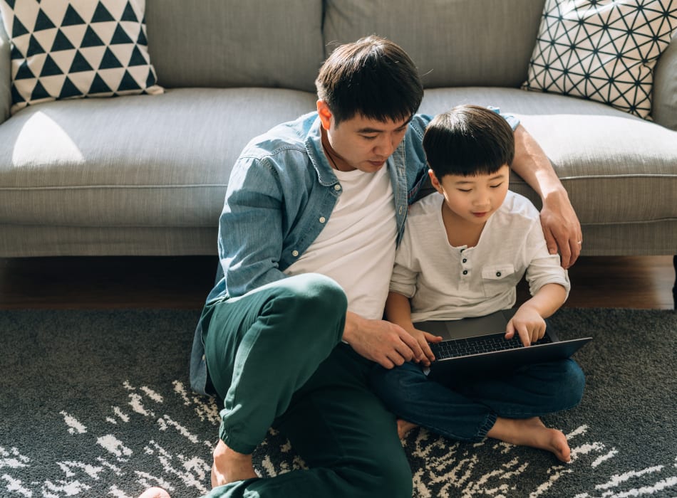 Resident father and son surf online together at Sofi at 50 Forest in Stamford, Connecticut