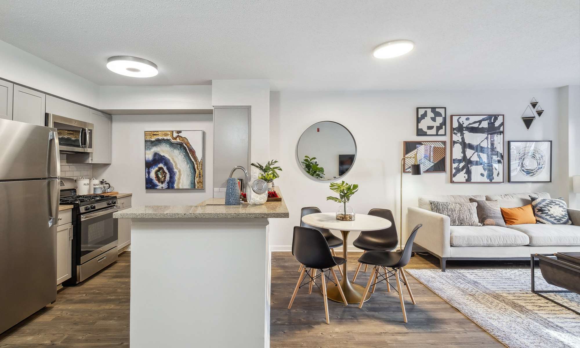 Open-concept Kitchen With Stainless Steel Appliances and Living Area at Sofi at 50 Forest in Stamford, Connecticut