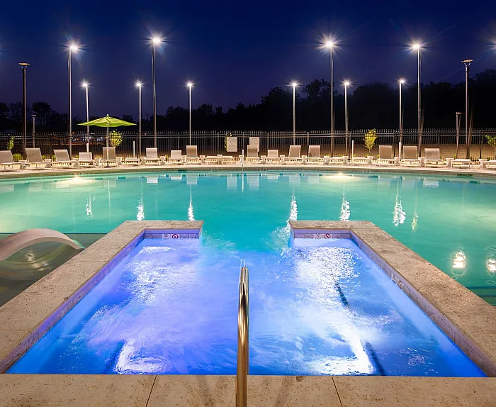 Large pool with lounge chairs at College View apartments in Starkville, MS.