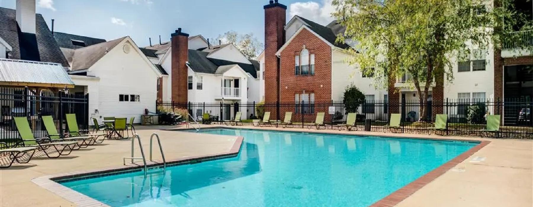 a swimming pool in front of a row of houses