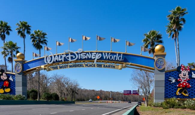 a Walt Disney world sign over a road
