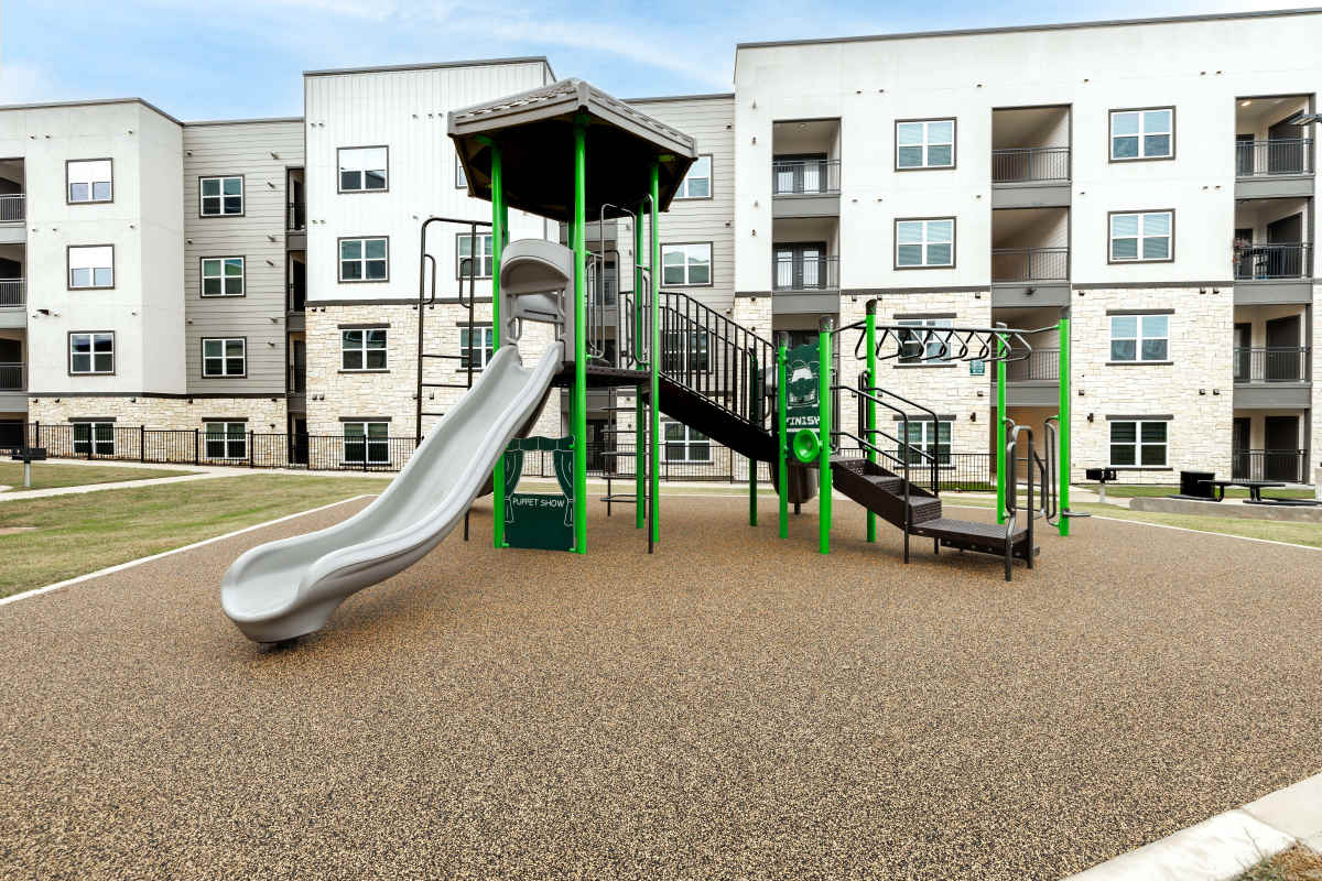 Kid playing in playground at Walnut Springs in Seguin, Texas