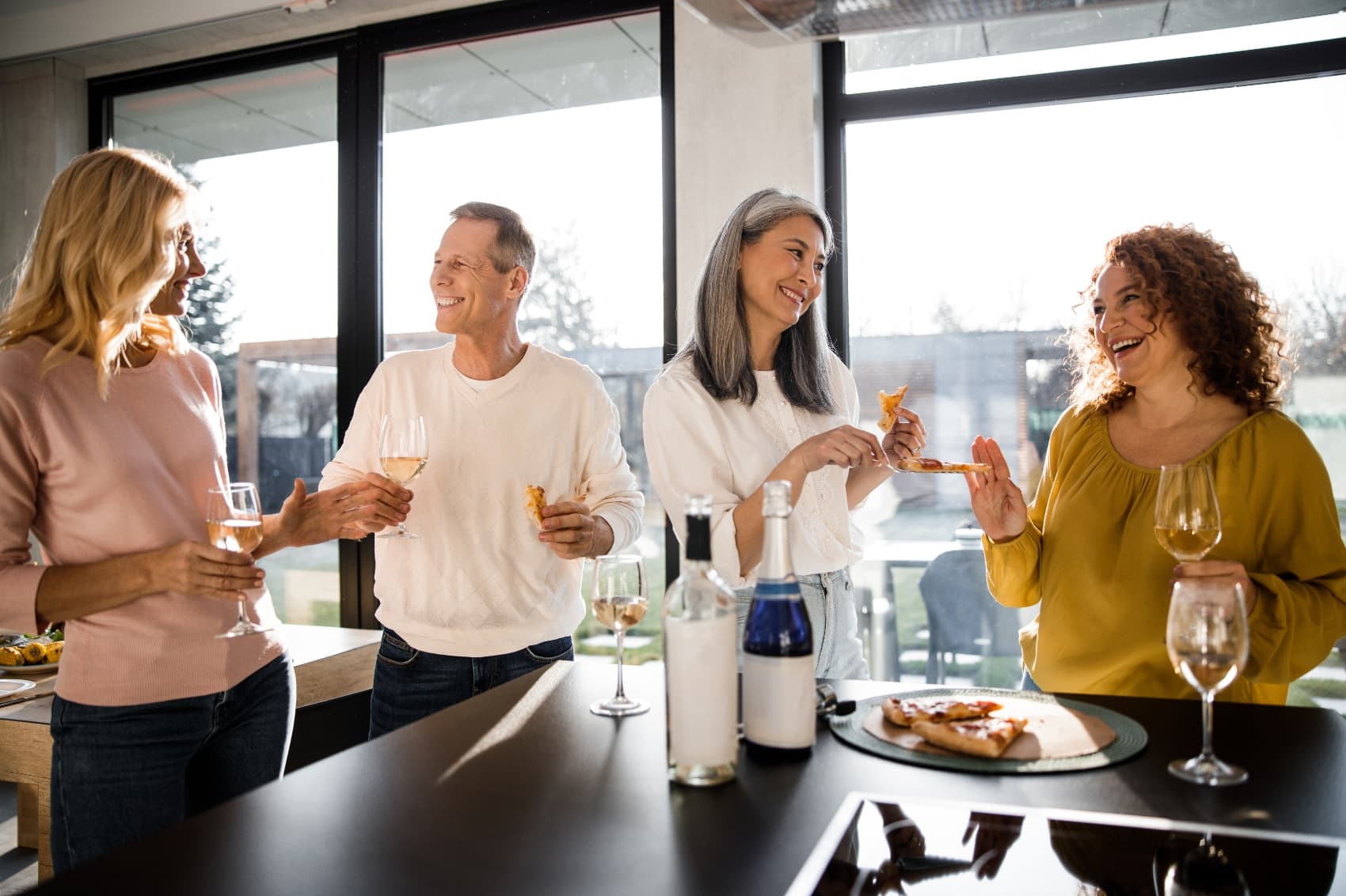 Groups of Residents enjoying wine and pizza during a social gathering at Livana Fair Lawn in New Jersey.