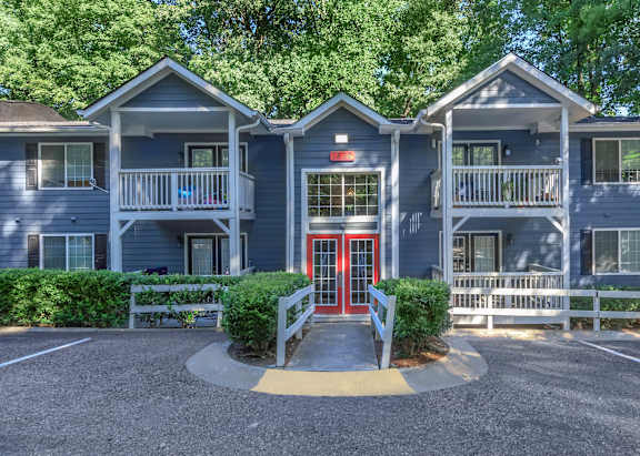 A building with a red door and a white fence in front at Crest at East Cobb Apartments, GA, 30062