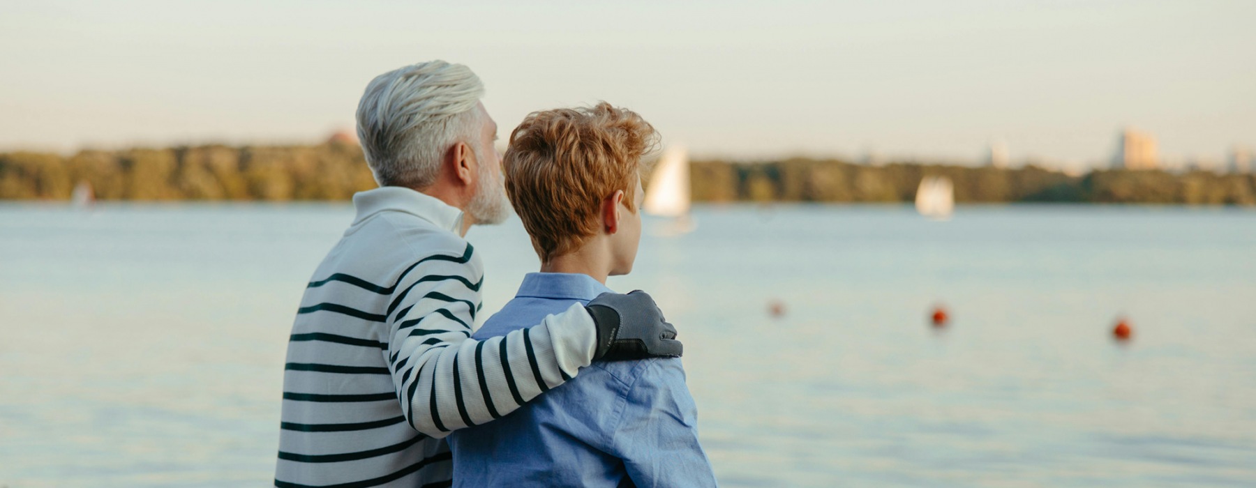 Father and son sitting on the dock