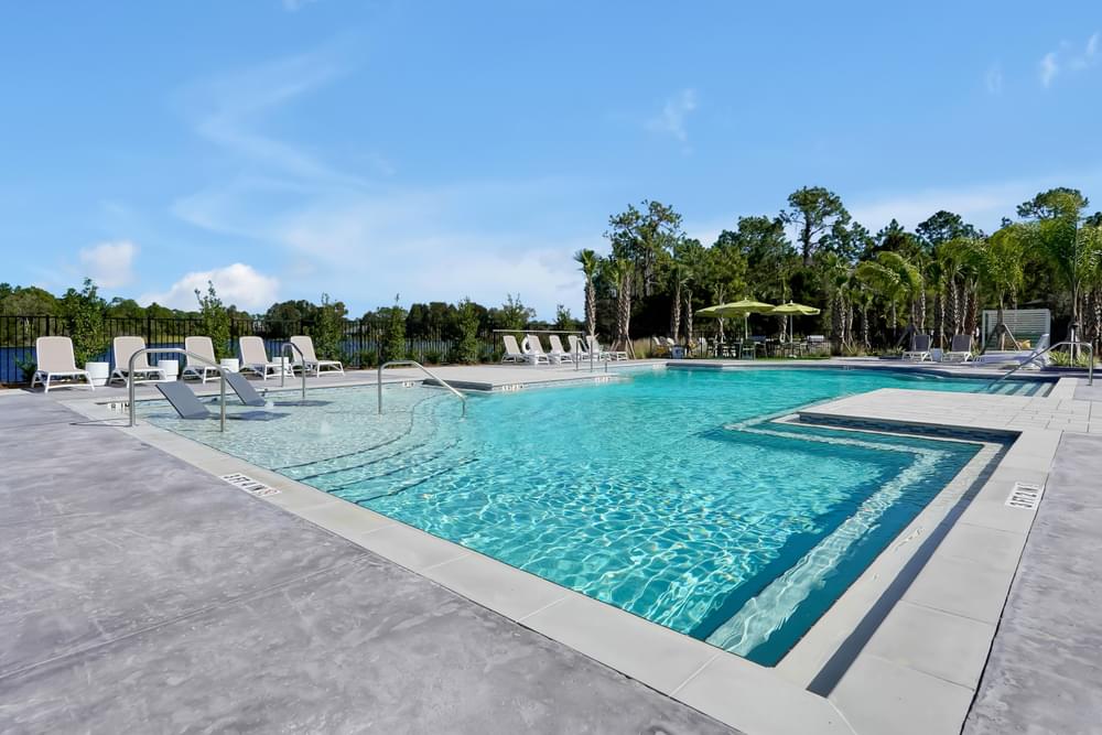 A large swimming pool with a yellow water slide.