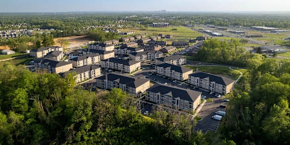 A bird's eye view of a residential area with multiple houses and a parking lot.
