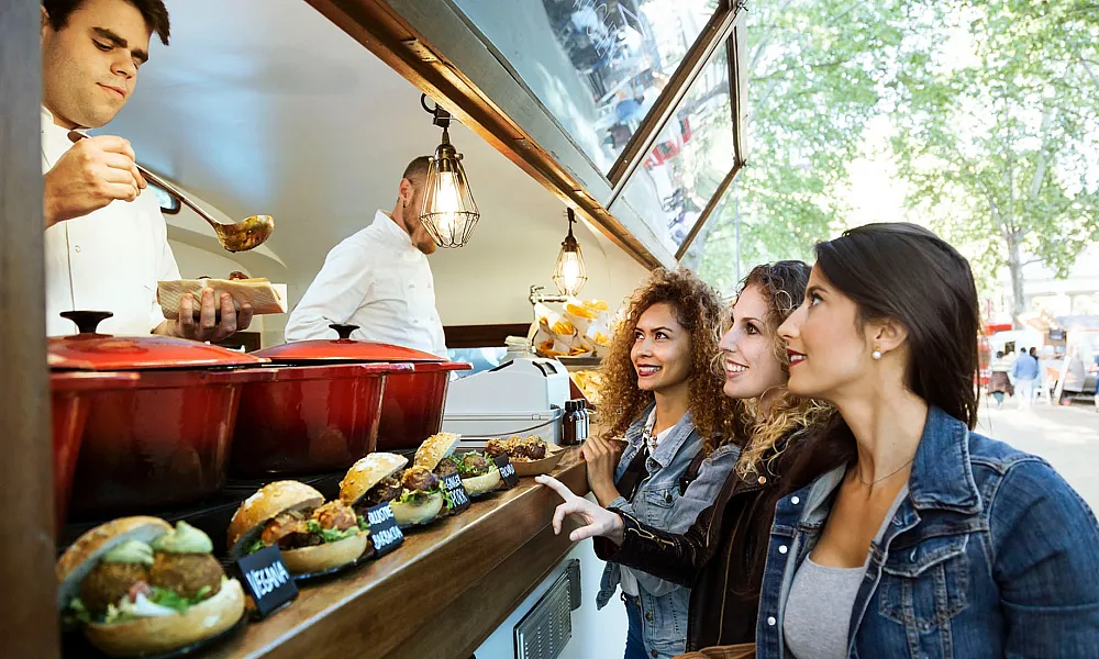 three women ordering at a food truck
