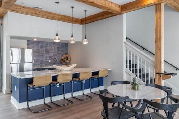 a kitchen with a blue island and a table with chairs at Bristol at New Riverside, Bluffton, SC 29910