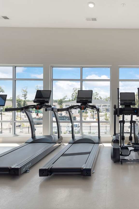 a workout room with treadmills and a tv at Bristol at New Riverside Apartments, Bluffton, SC, 29910