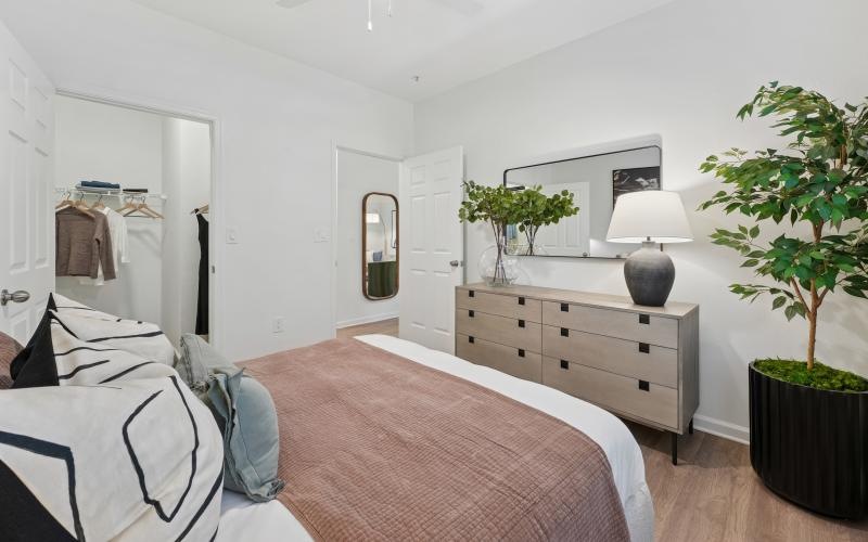 a bedroom with a bed and a plant