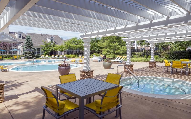 a pool with chairs and a table
