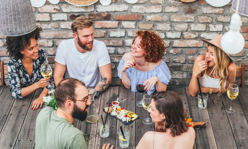 group of people eating at restaurant over dinner