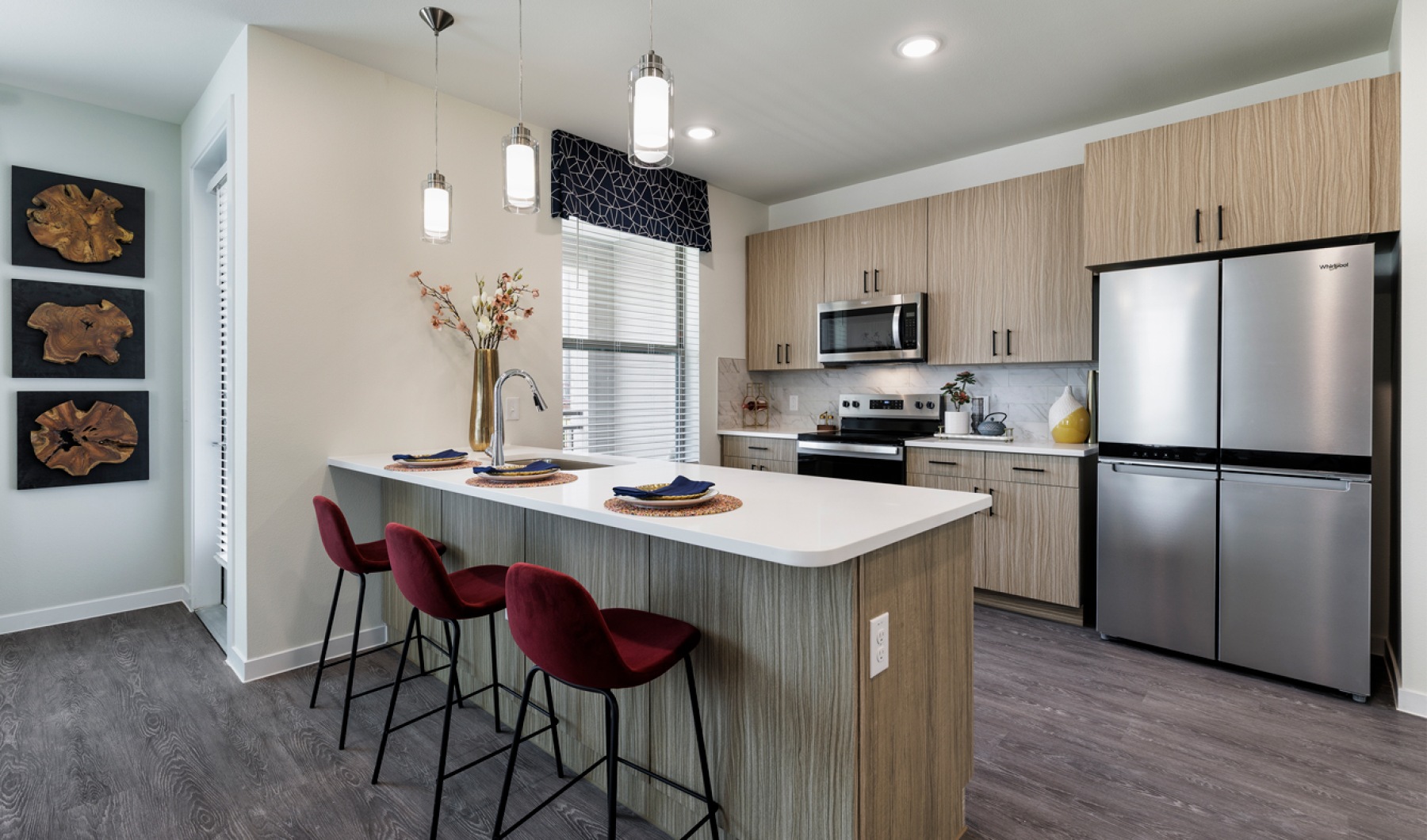 Modern kitchen with large breakfast bar at The Bower Pflugerville, TX apartments.